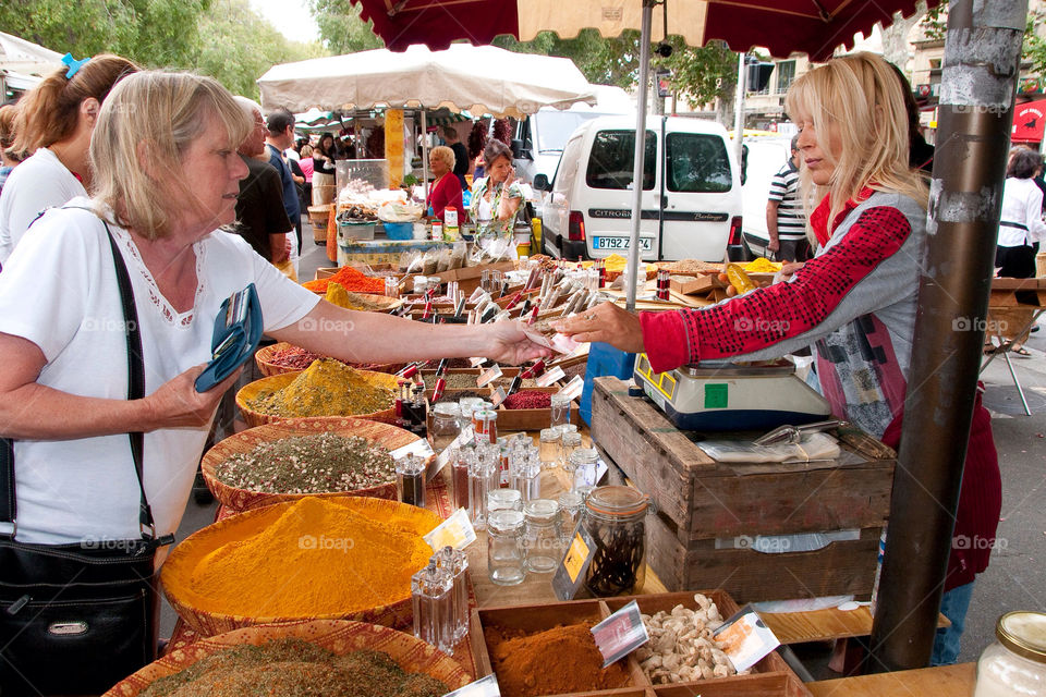 Woman purchasing spices at the farmers market in France