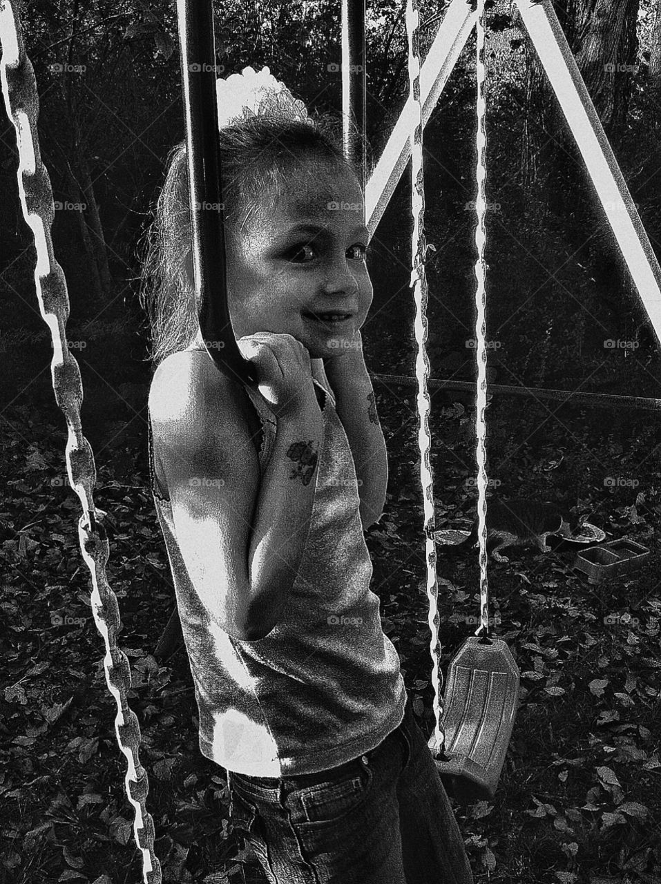 A little girl plays on a swing set in a small town in rural Arkansas