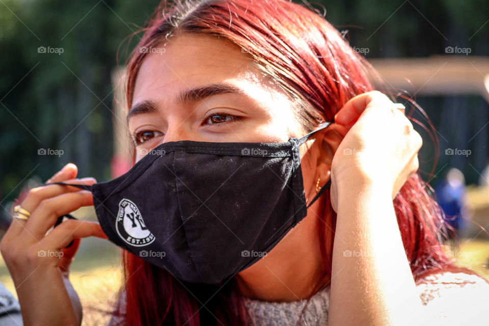 Teen girl is putting on a face mask