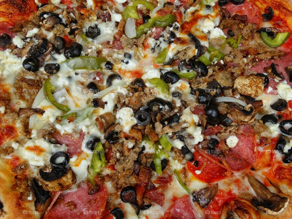 Pizza Overflowing With A Variety Of Toppings