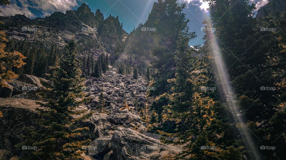 Rocky mountainous landscapes covered in light rays.