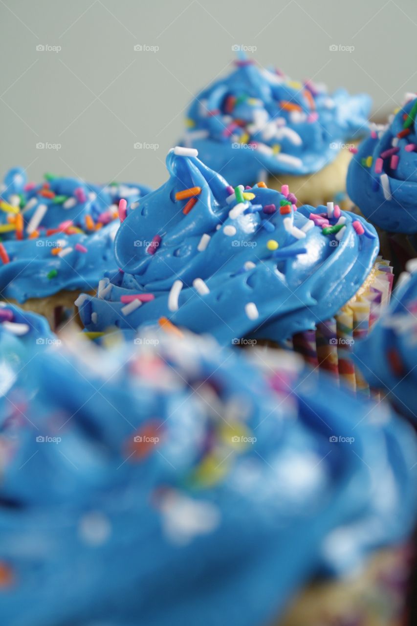 Blue Frosted Cupcakes. A grouping of cupcakes with blue frosting and sprinkles.