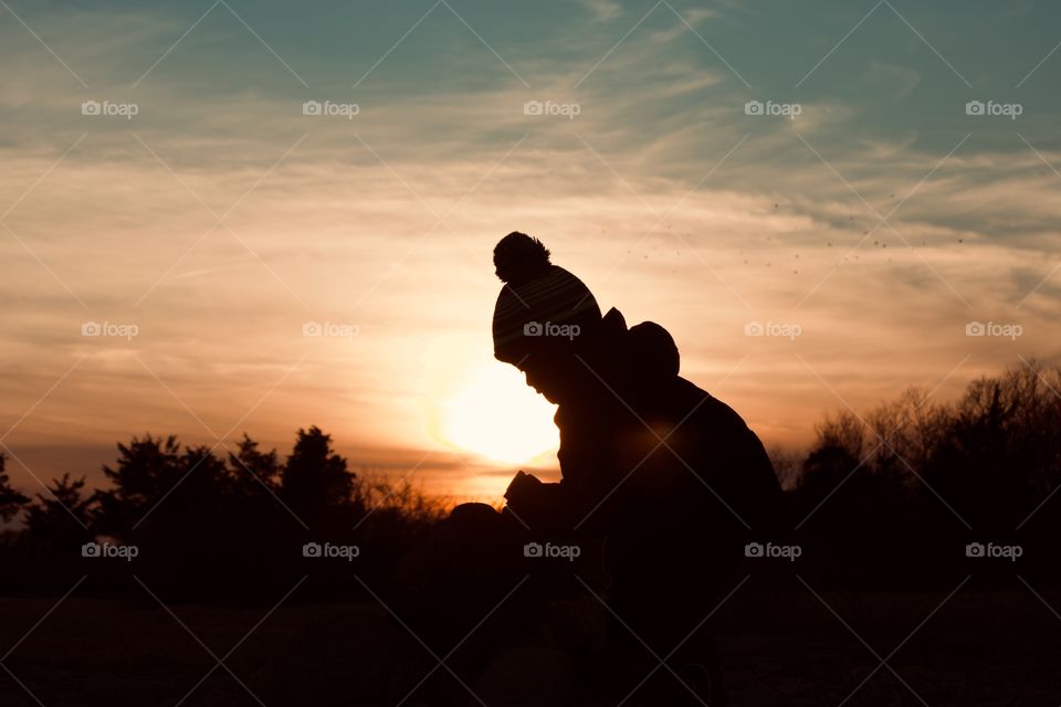 A little boy playing at sunset 