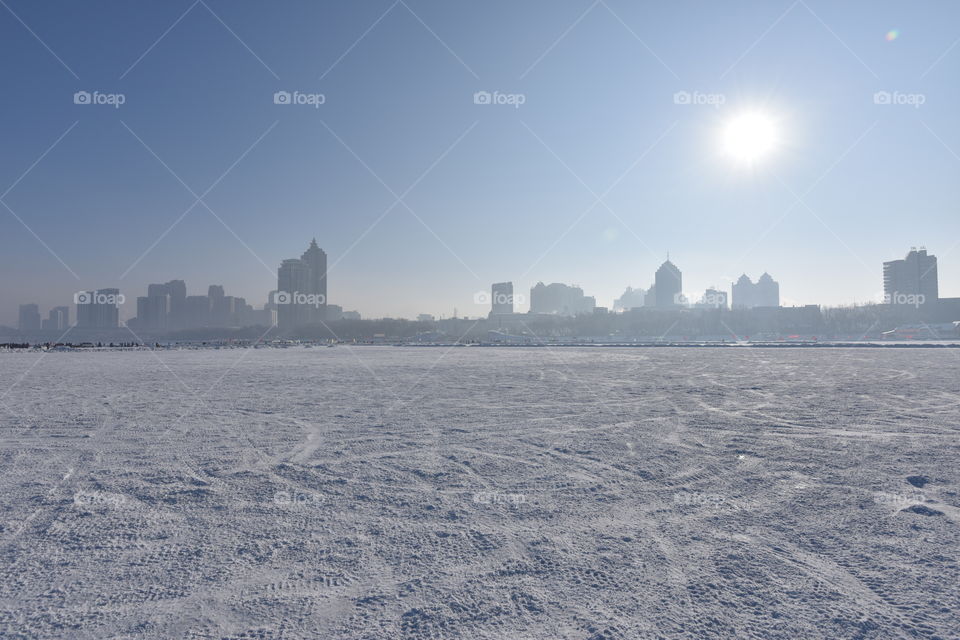 Asia china  Harbin ice Festival snow Festival frozen river snow ice with polar sun view to the city Harbin