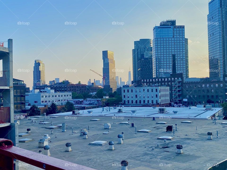 Returning from my trip to „Bushwick“ to pick up a prescription I took photos of the urban scenarios by the golden light of the setting evening sun and this view across the flat rooftops of „Greenpoint“, Bklyn is one. 2023. Hypnotic Productions
