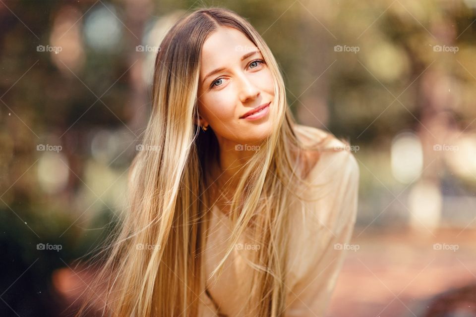 Portrait of beautiful young woman with blonde hair outdoor 