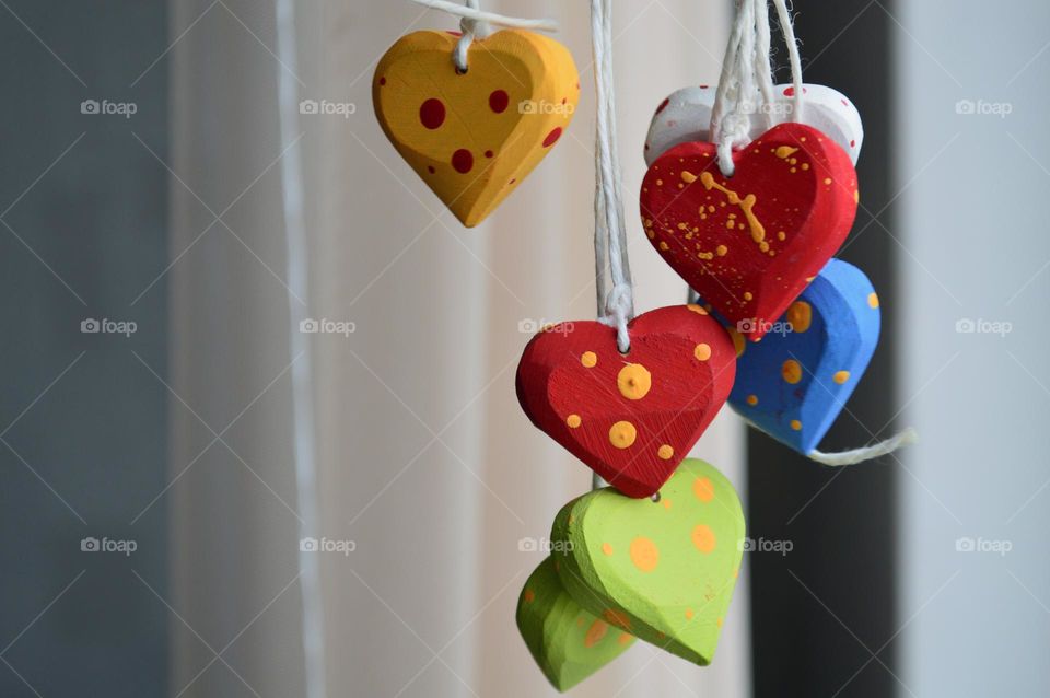 Multicolored wooden hearts on a thread