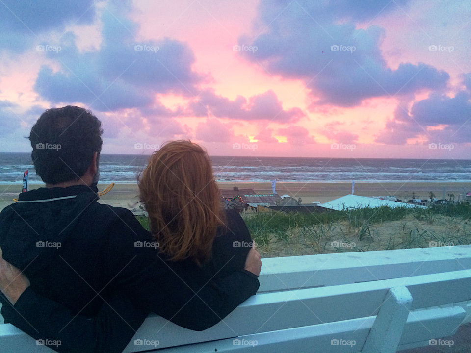 Couple watches a beautiful sunset