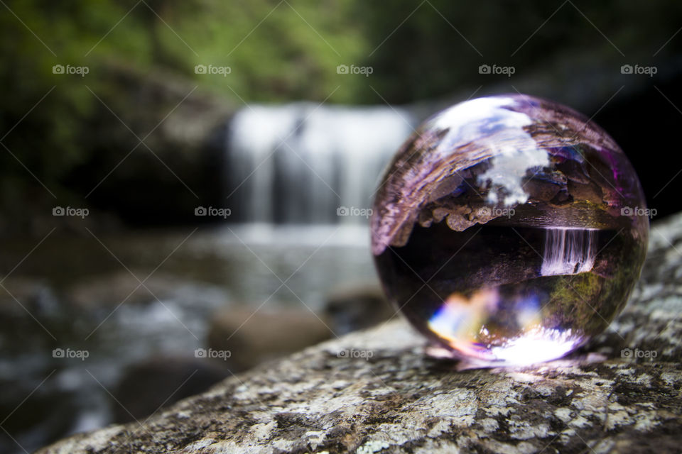 Glass ball on rock