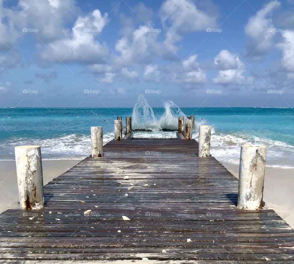 Powerful waves slamming a wooden pier