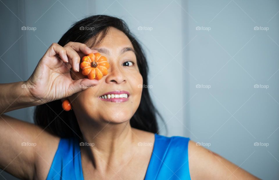 Portrait of a woman holding a pumpkin candle 