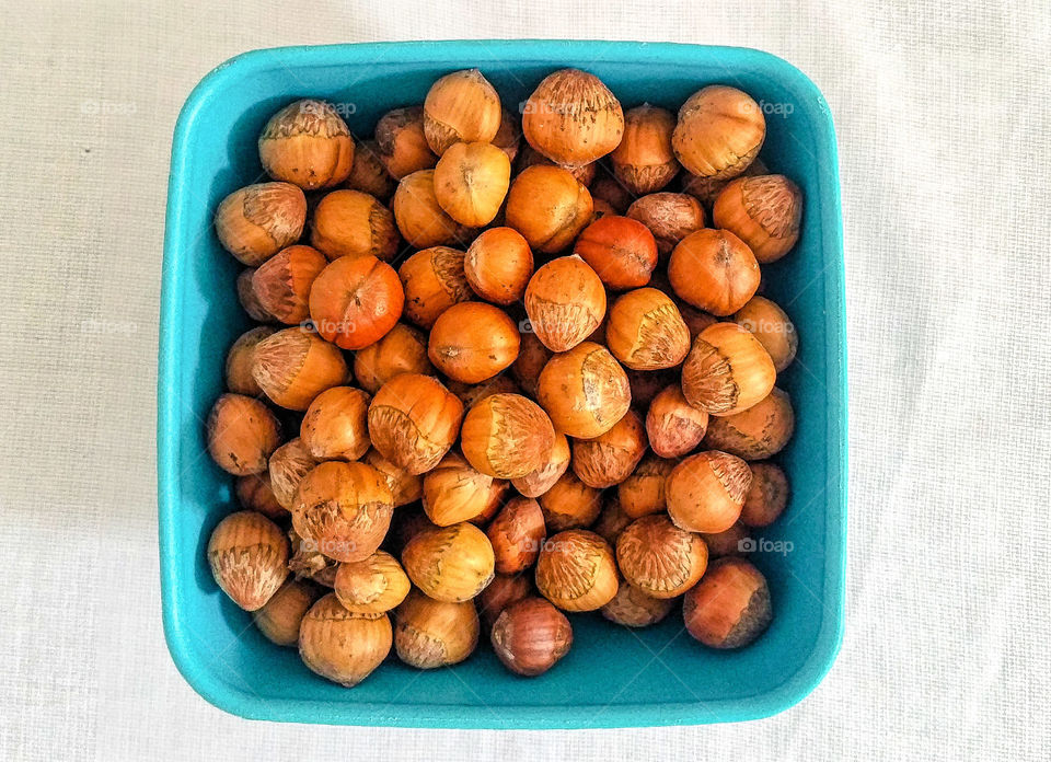 Hazelnuts in a blue bowl