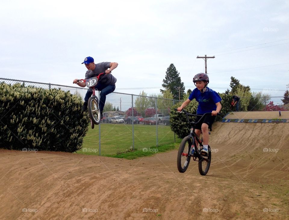 Gettin' Some Air. An experienced BMX bike rider showing a beginner how it's done.