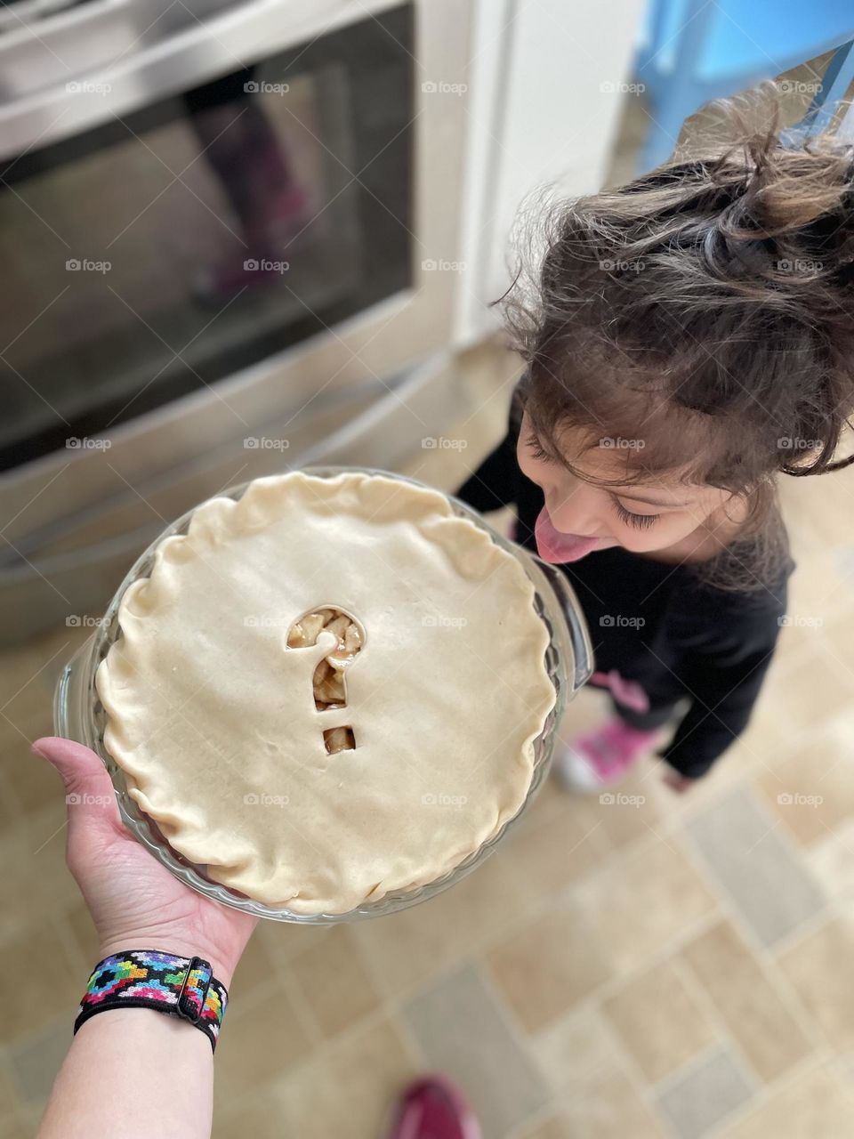 Toddler trying to eat pie on its way to the oven, toddler excited about pie, making apple pies with toddlers, delicious apple pie, baking pies at home