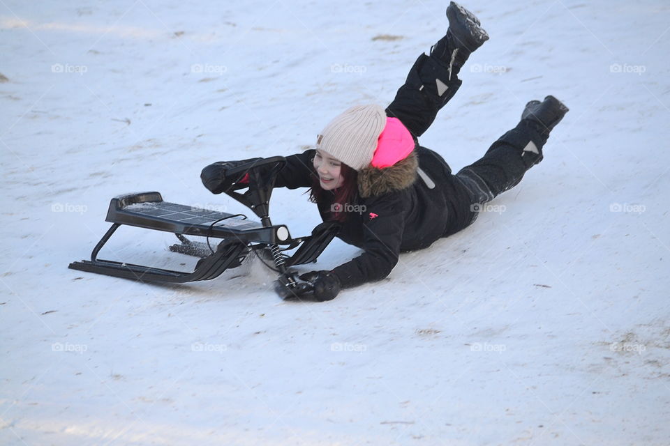 Girl crashes with her sled