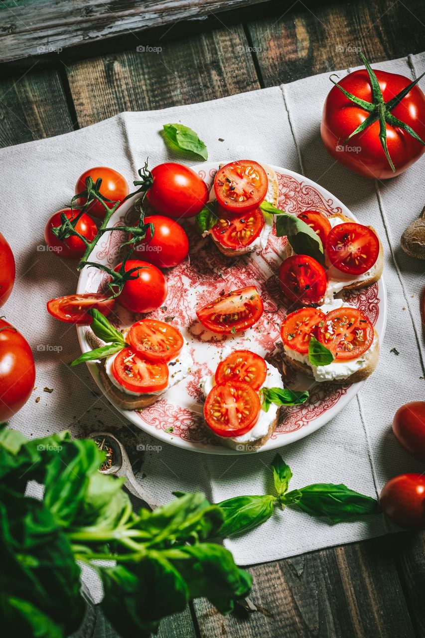 Fresh tomatoes with cheese on canape