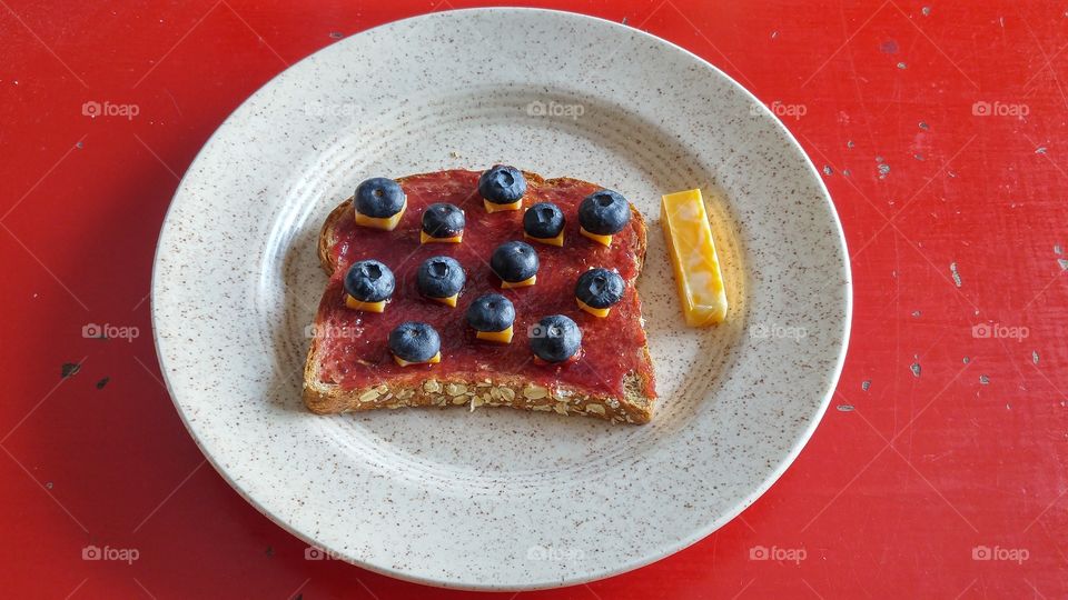 Toasted raspberry fruit spread blueberries and cheese
