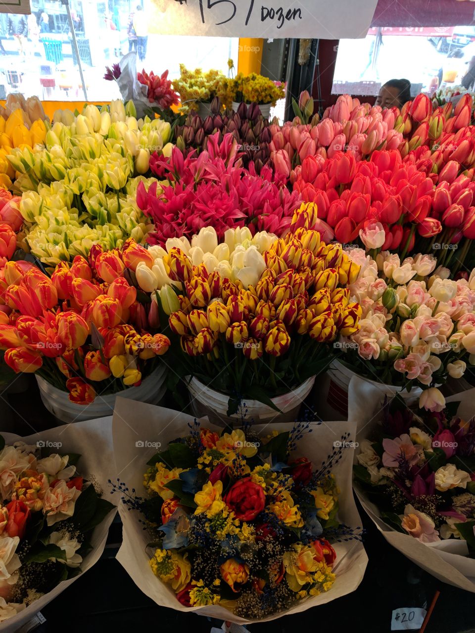 Delicate tulips, and flower arrangements. Vast numbers of bouquets available at farmer's market in Seattle, Washington.