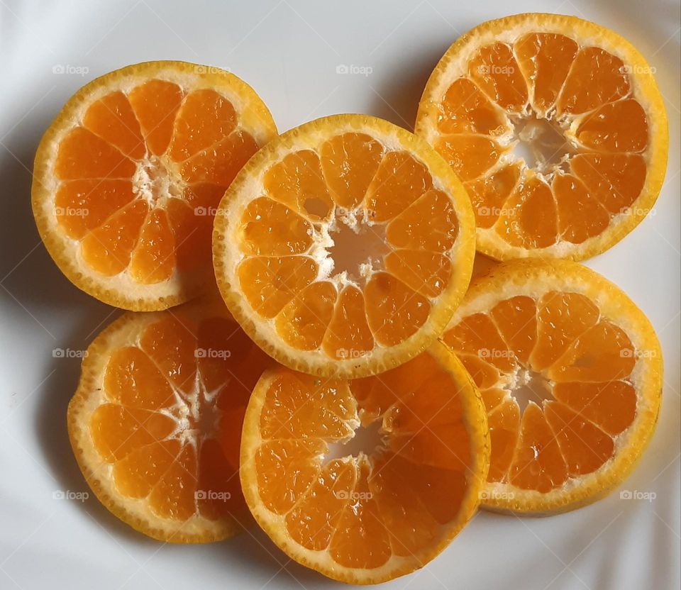 Slice of orange fruit isolated on white background. Top view