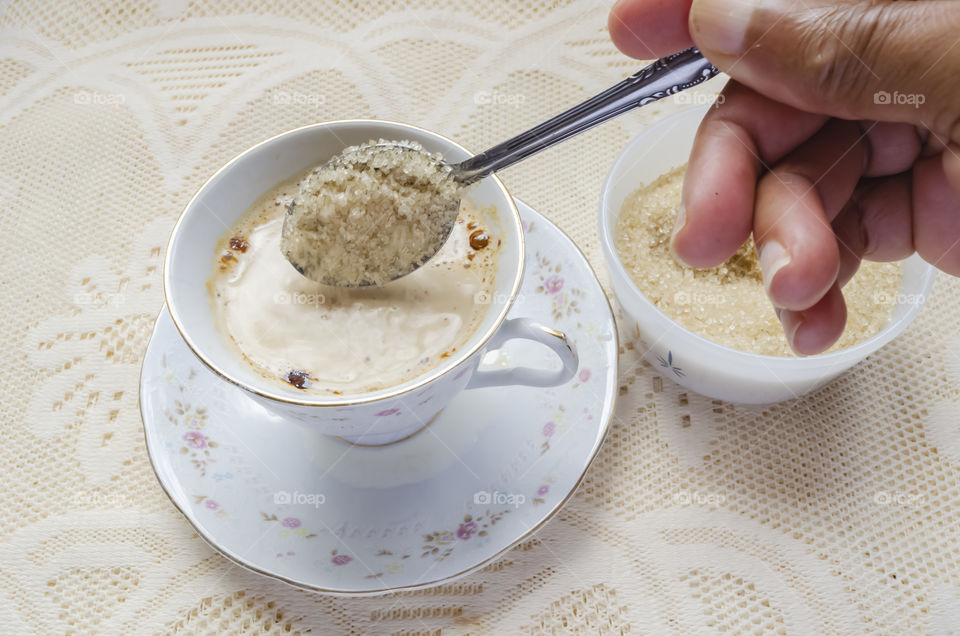 Adding Sugar To Coffee Cup