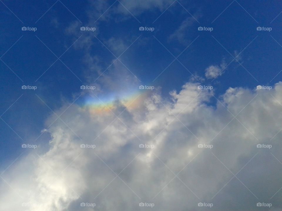 Blue sky, white clouds and rainbow