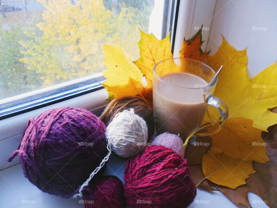 Warm socks, coffee with milk and autumn leaves