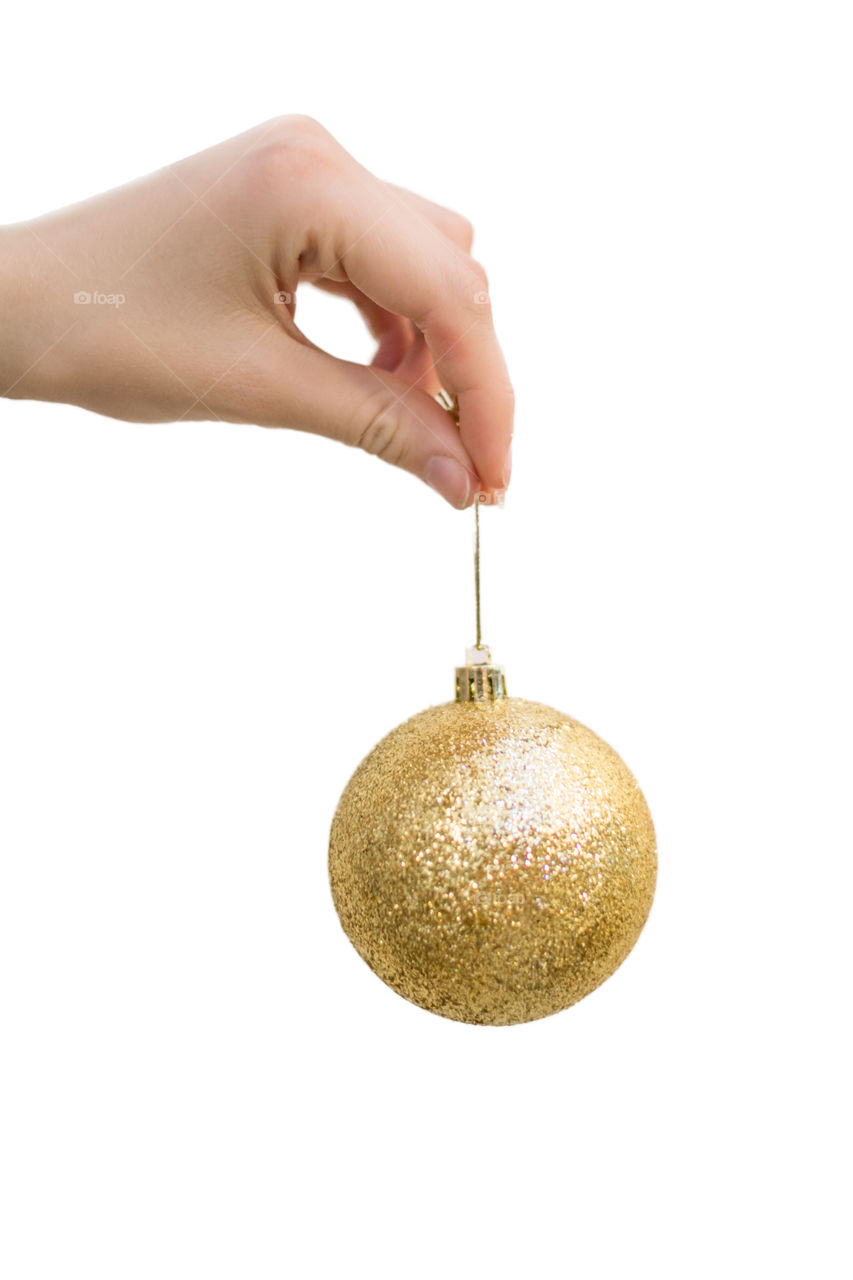 shiny Christmas ball on a string in his hand