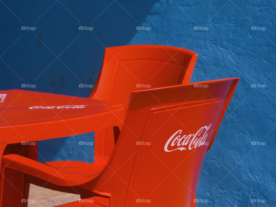 Coca-Cola outdoors. Red chairs