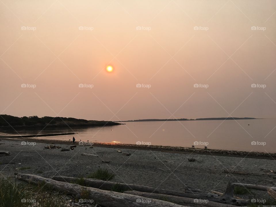 Hazy sky  reflects in the ocean