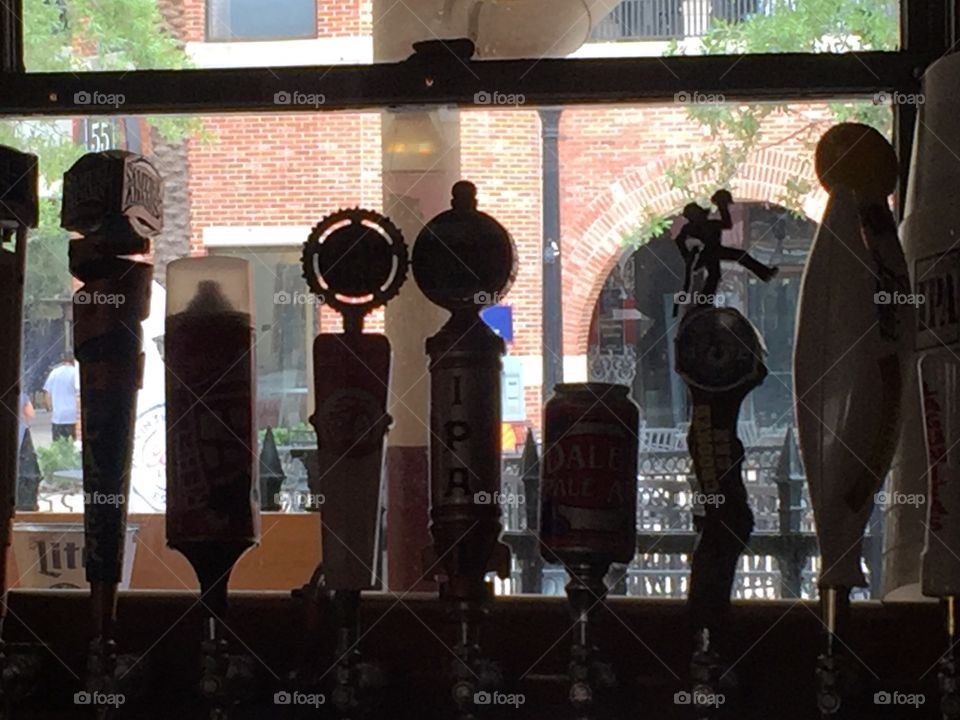Silhouette of beer taps in a bar