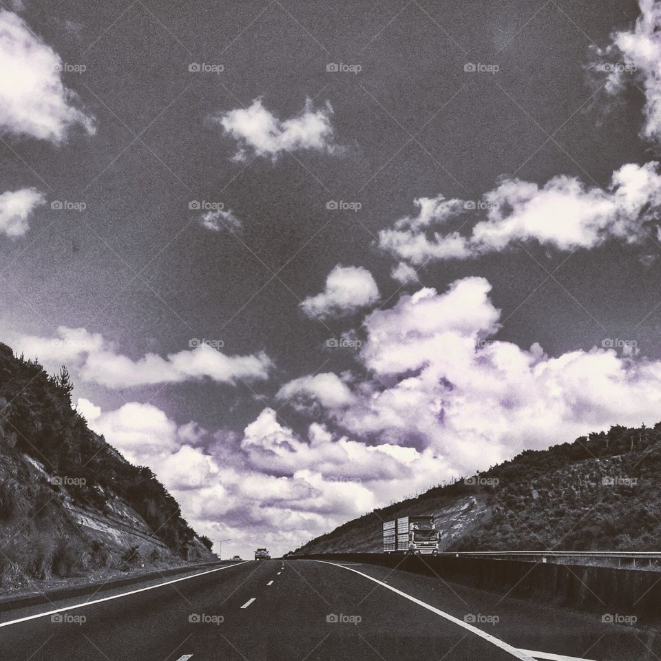 Vanishing point view of a motorway cutting through a hillside 