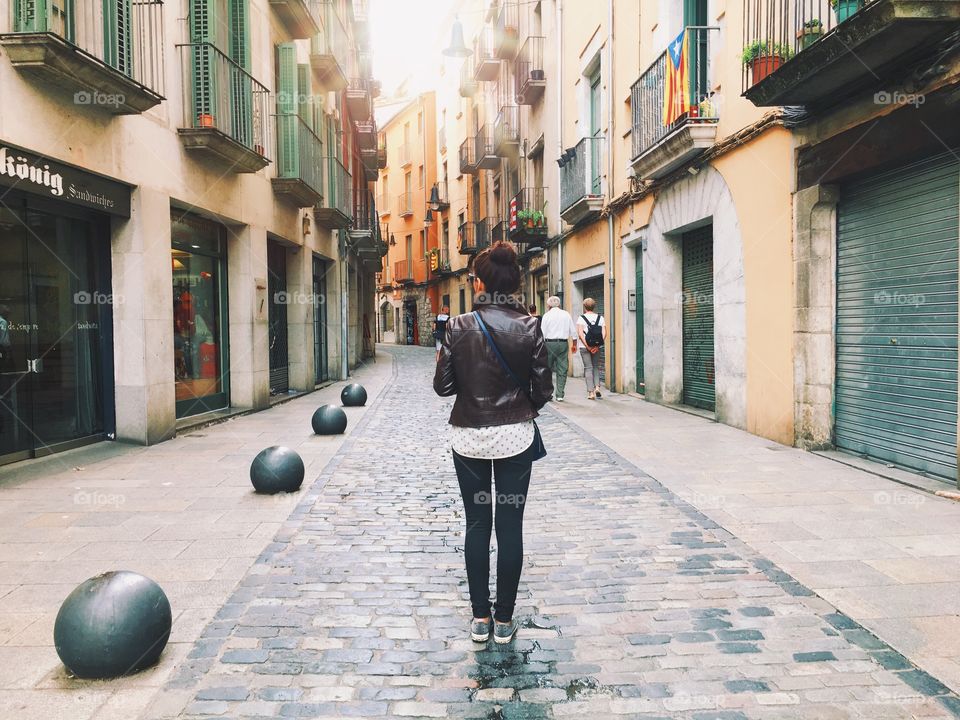 A girl walking in the old town