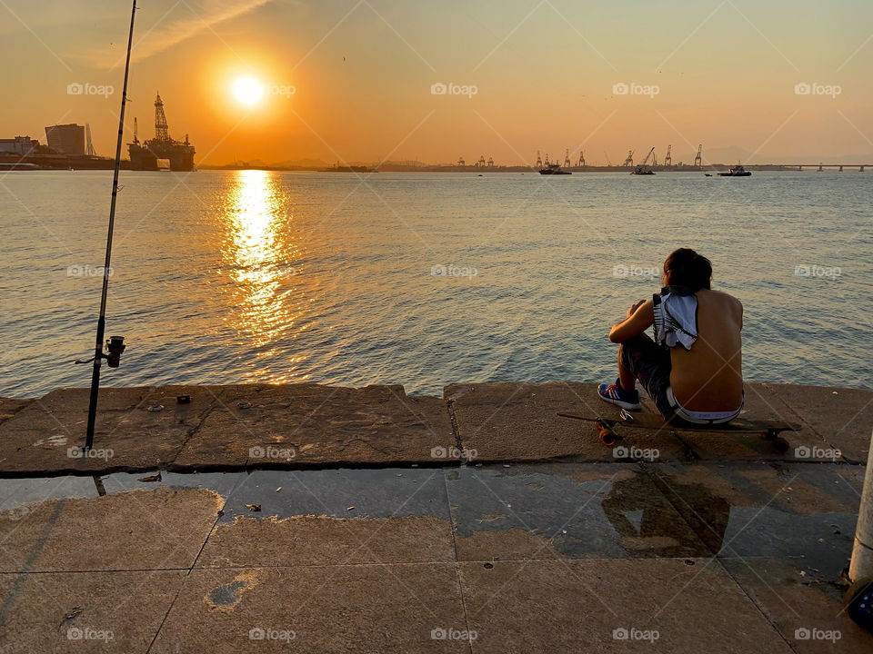 Golden hour in the city . Fishing and skating 
