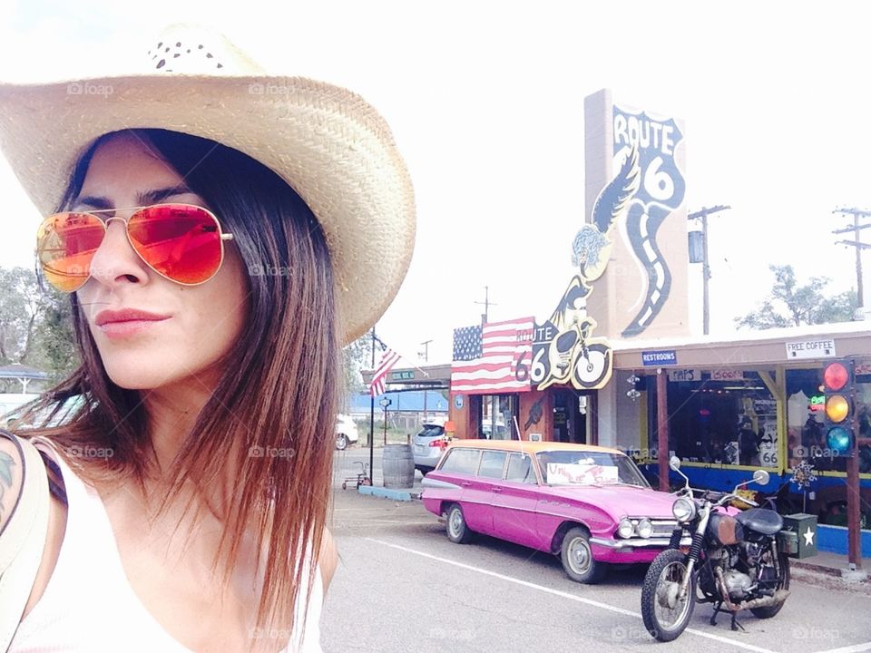 Cow boy Woman take a selfie in front of the store in the route 66