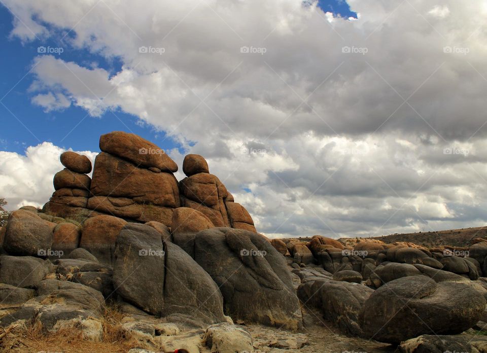 rolling clouds on rocky hills