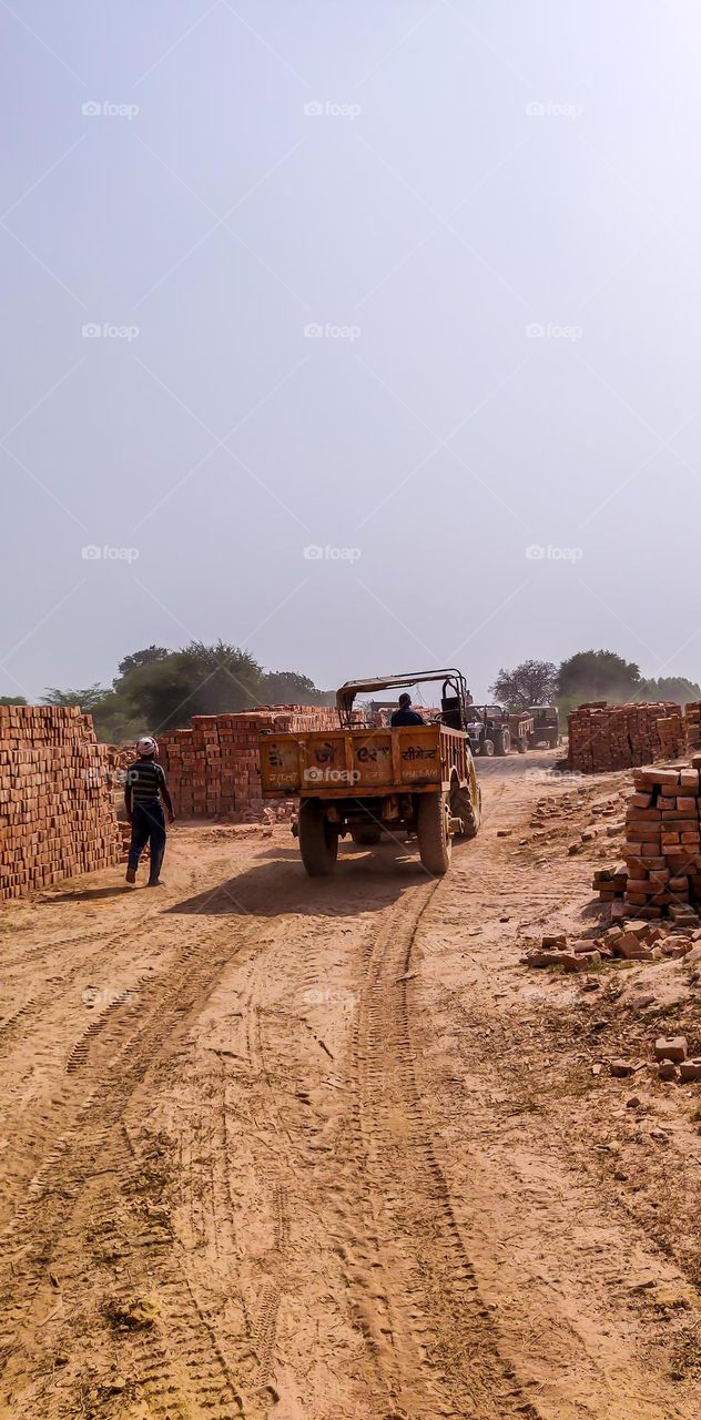 Tractor transporting bricks