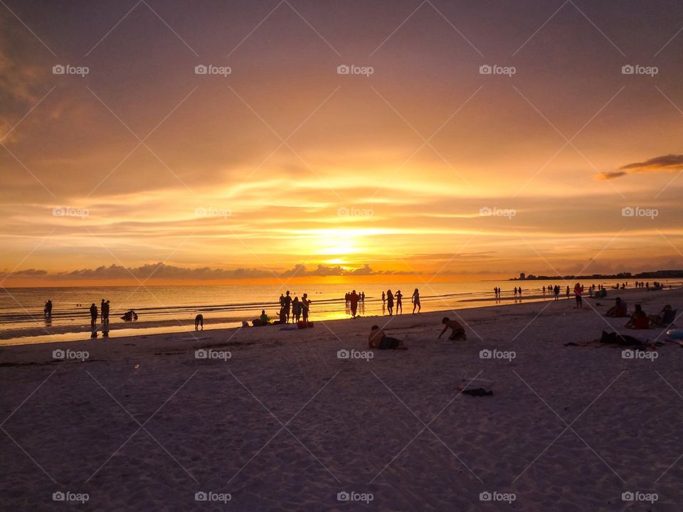 Busy beach at sunset