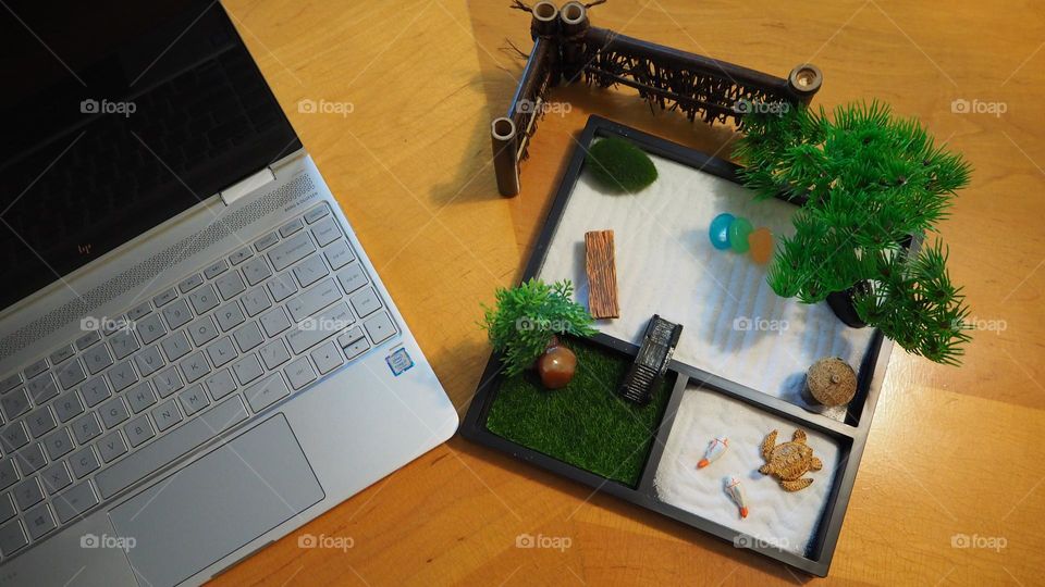 Work happy with a great laptop and a zen garden on an uncluttered desk