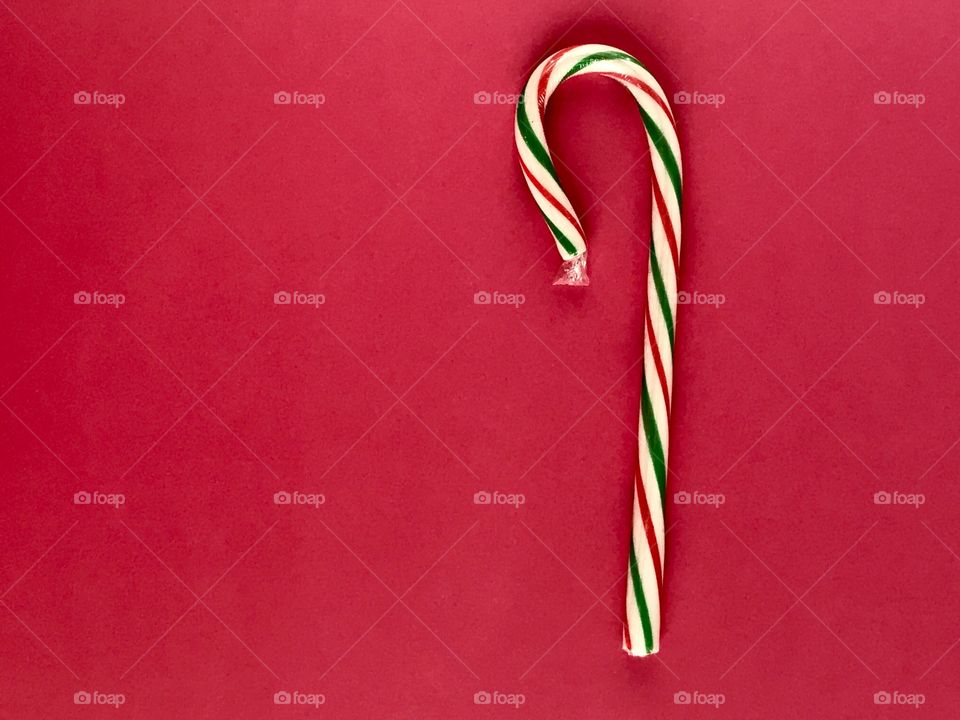 A candy cane on a red background 