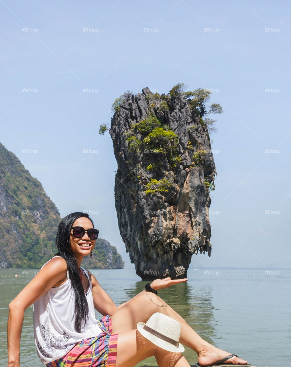 Close-up of a young woman sitting near sea