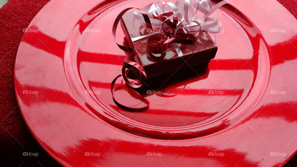 High angle view of gift on red plate