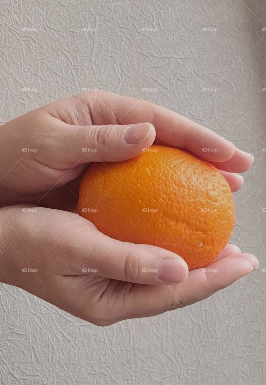 orange in hand