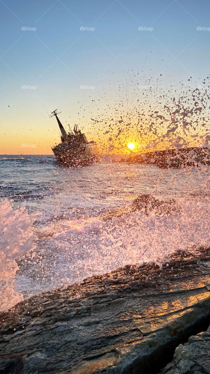 Waves at sunset time by the shipwreck in Paphos. A place for amazing photos . 