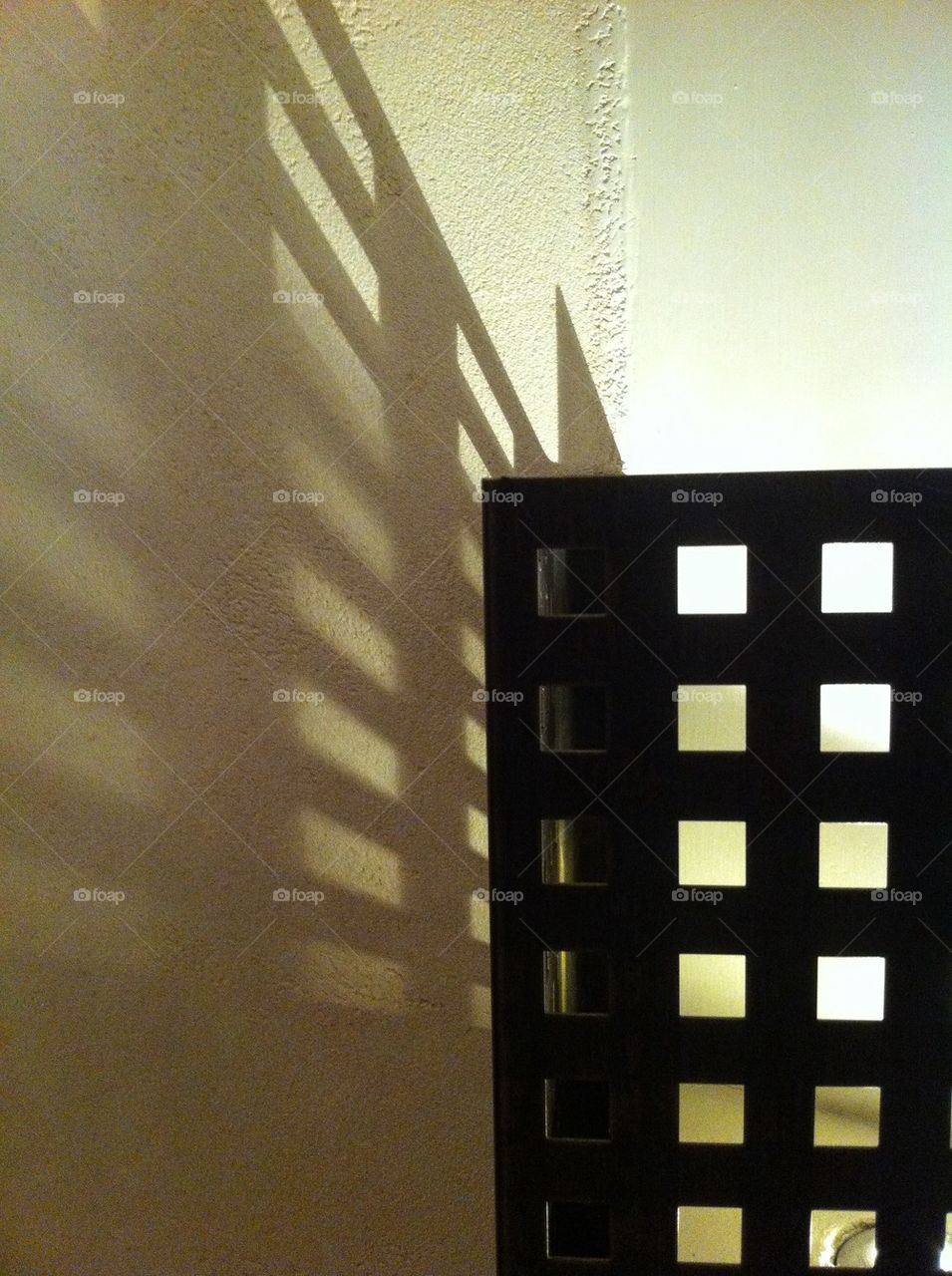 Designed lamp dropping shadow on a wall