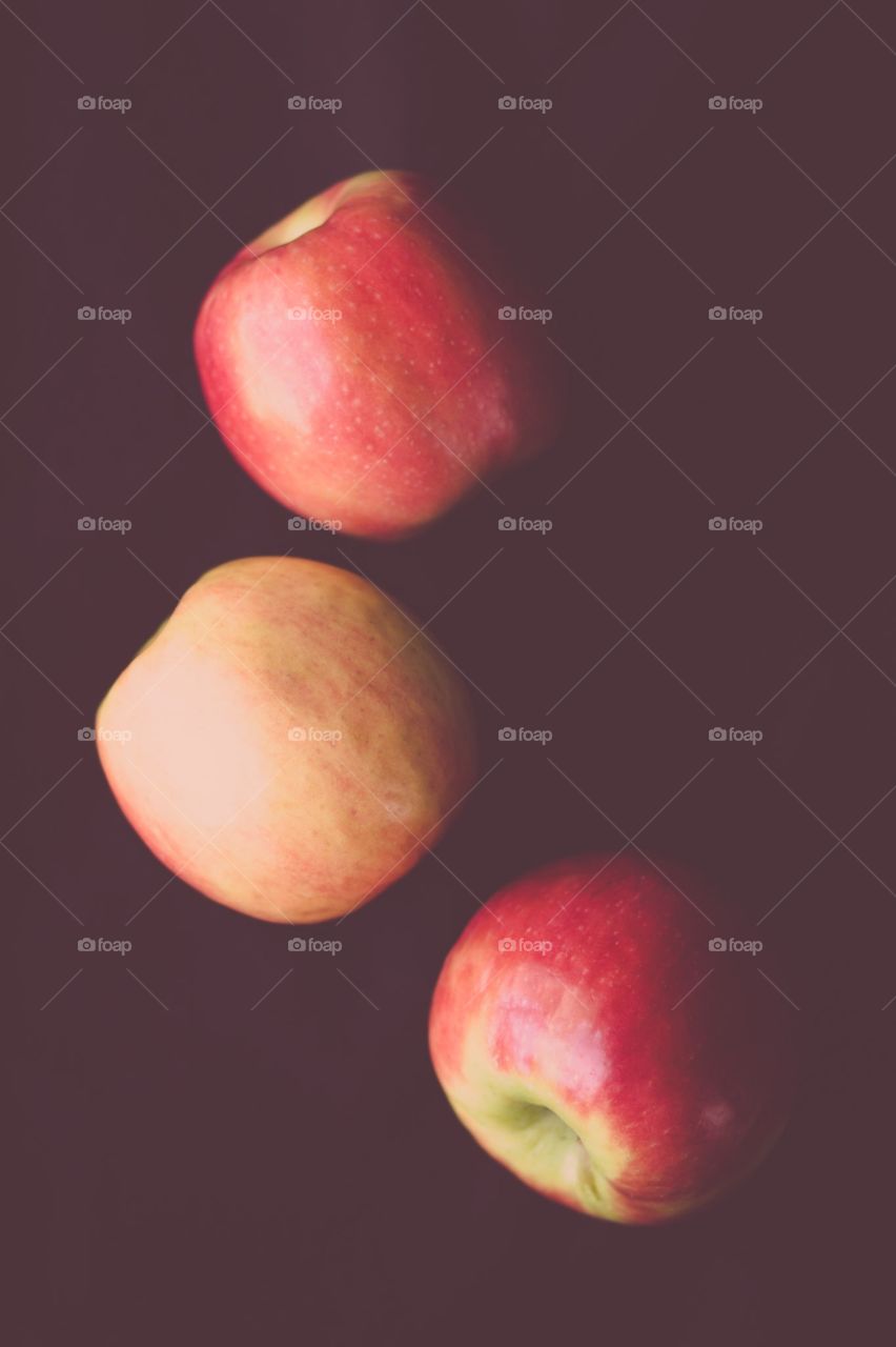 Three Apples. Three Fuji apples on a dark background