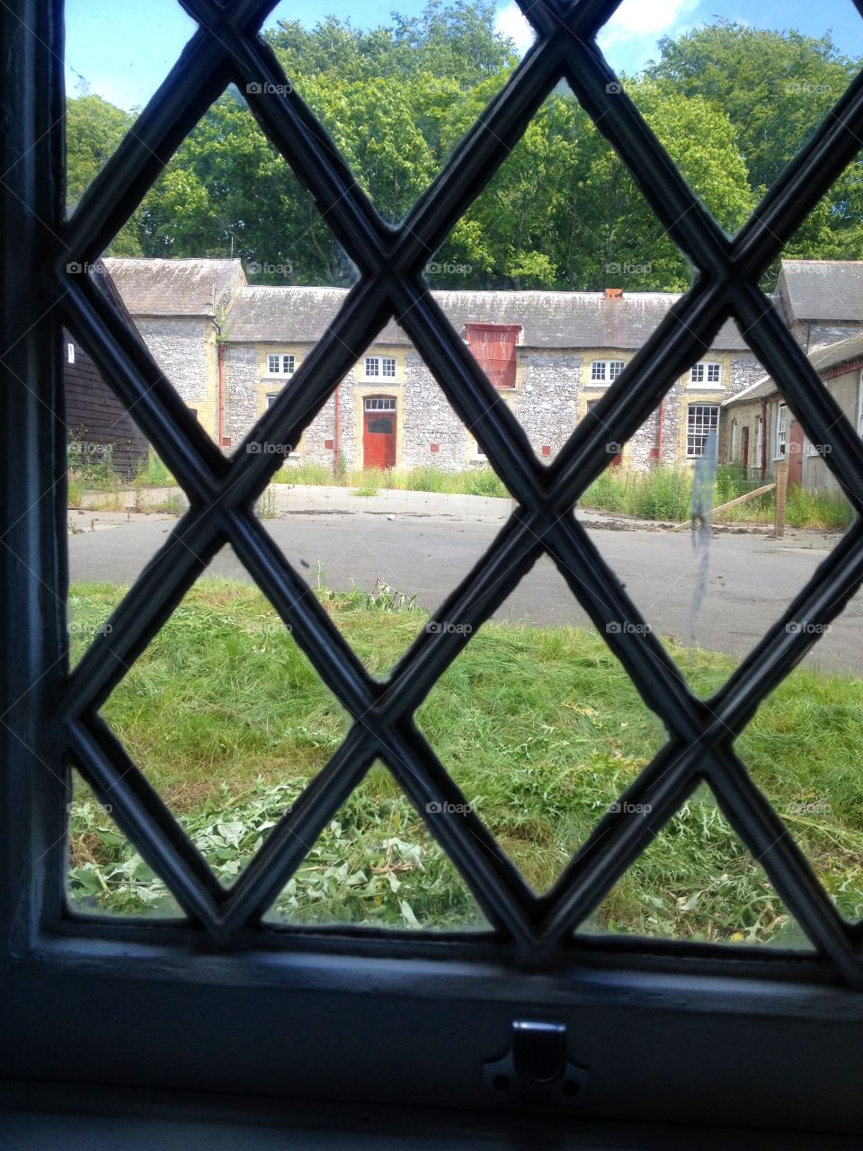Windows around the world. Original old latticed window in cottage belonging to Arundel Castle's horse racing stables, in West Sussex.