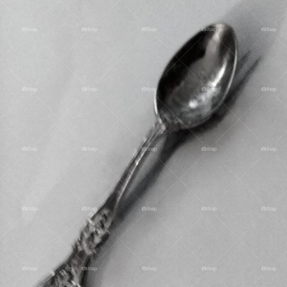 black and white photo of a silver spoon