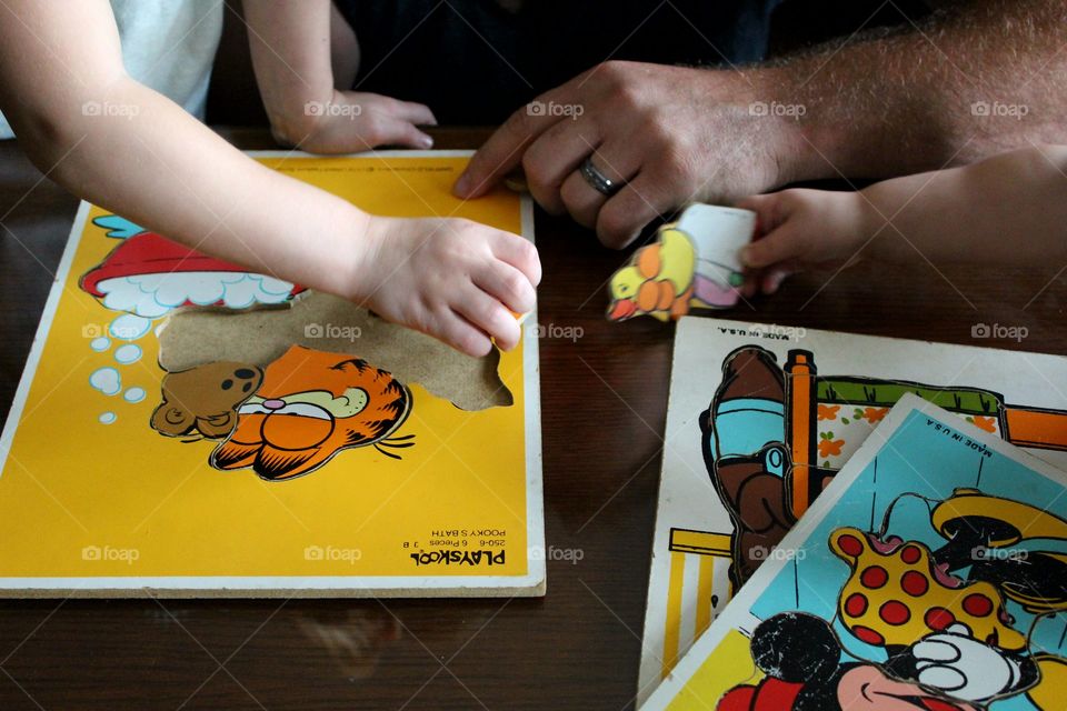 Daddy helping daughter with puzzle