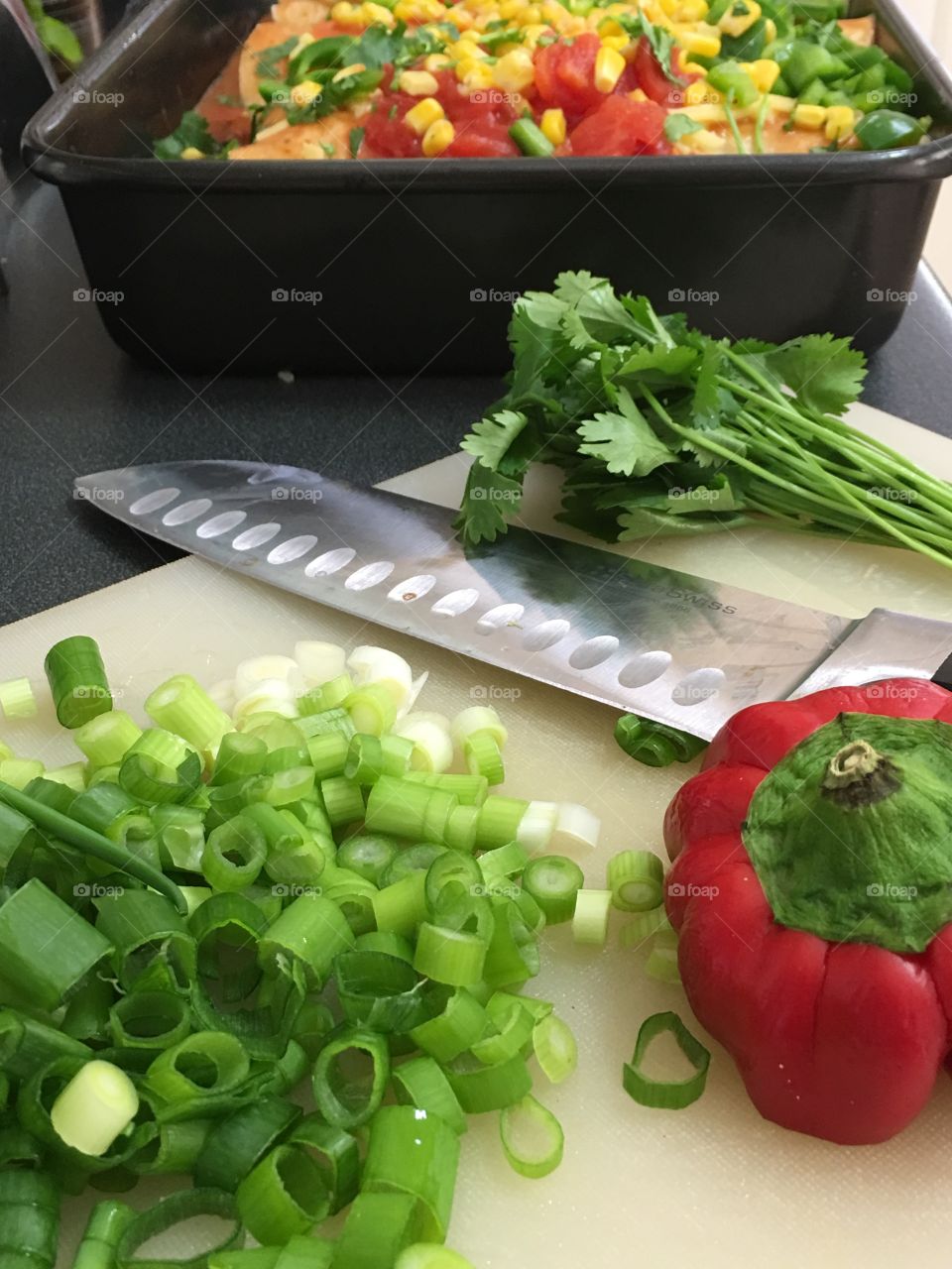 Large knife on a cutting board, preparing, slicing, diving, chopping vegetables 