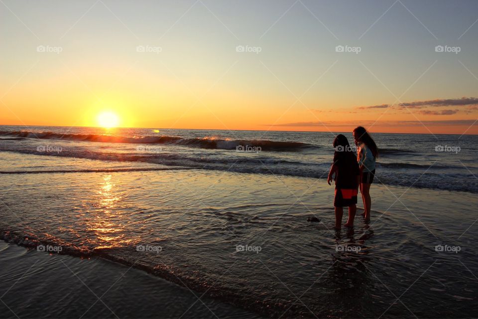 Searching for seashells at dawn. 